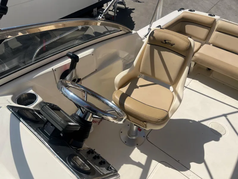 Slide: The Image of 2019 Scout 210 Dorado boat interior with steering wheel and captain's chair. - 12