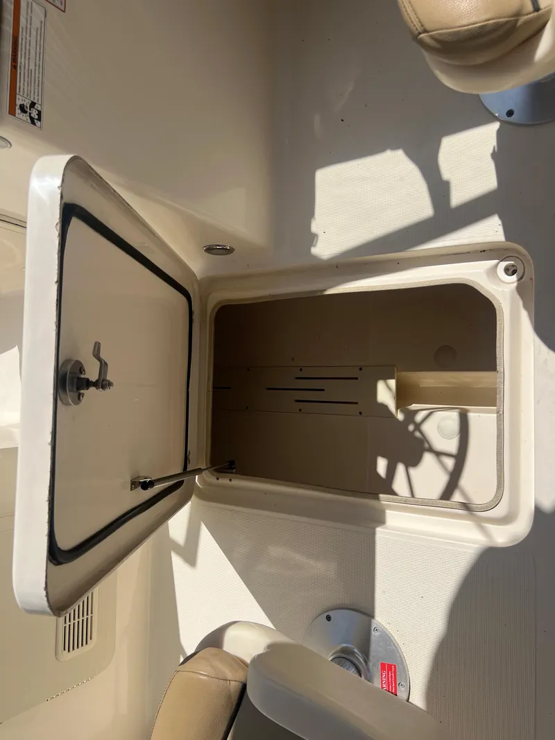 Slide: The Image of 2019 Scout 210 Dorado storage compartment with open hatch. - 15