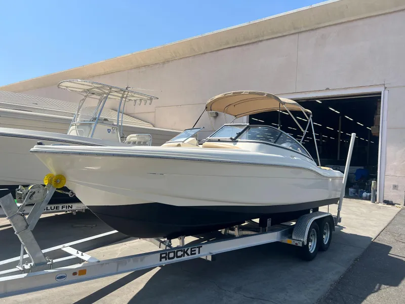 Slide: The Image of 2019 Scout 210 Dorado boat on a trailer outside a warehouse. - 3