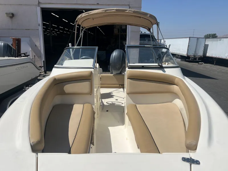 Slide: The Image of 2019 Scout 210 Dorado boat with beige seating and canopy. - 5