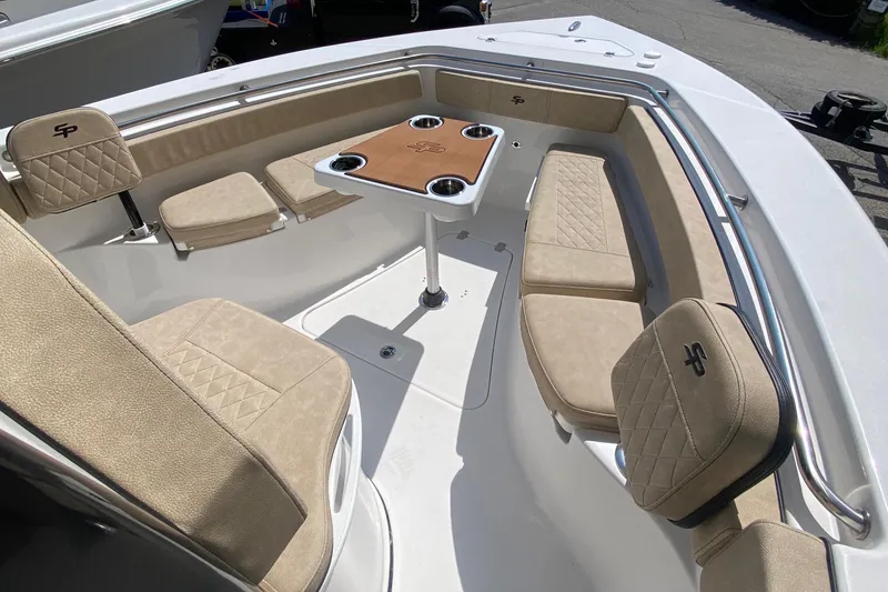 Slide: The Image of 2023 Sea Pro 239 boat interior with beige seating and a central table. - 10