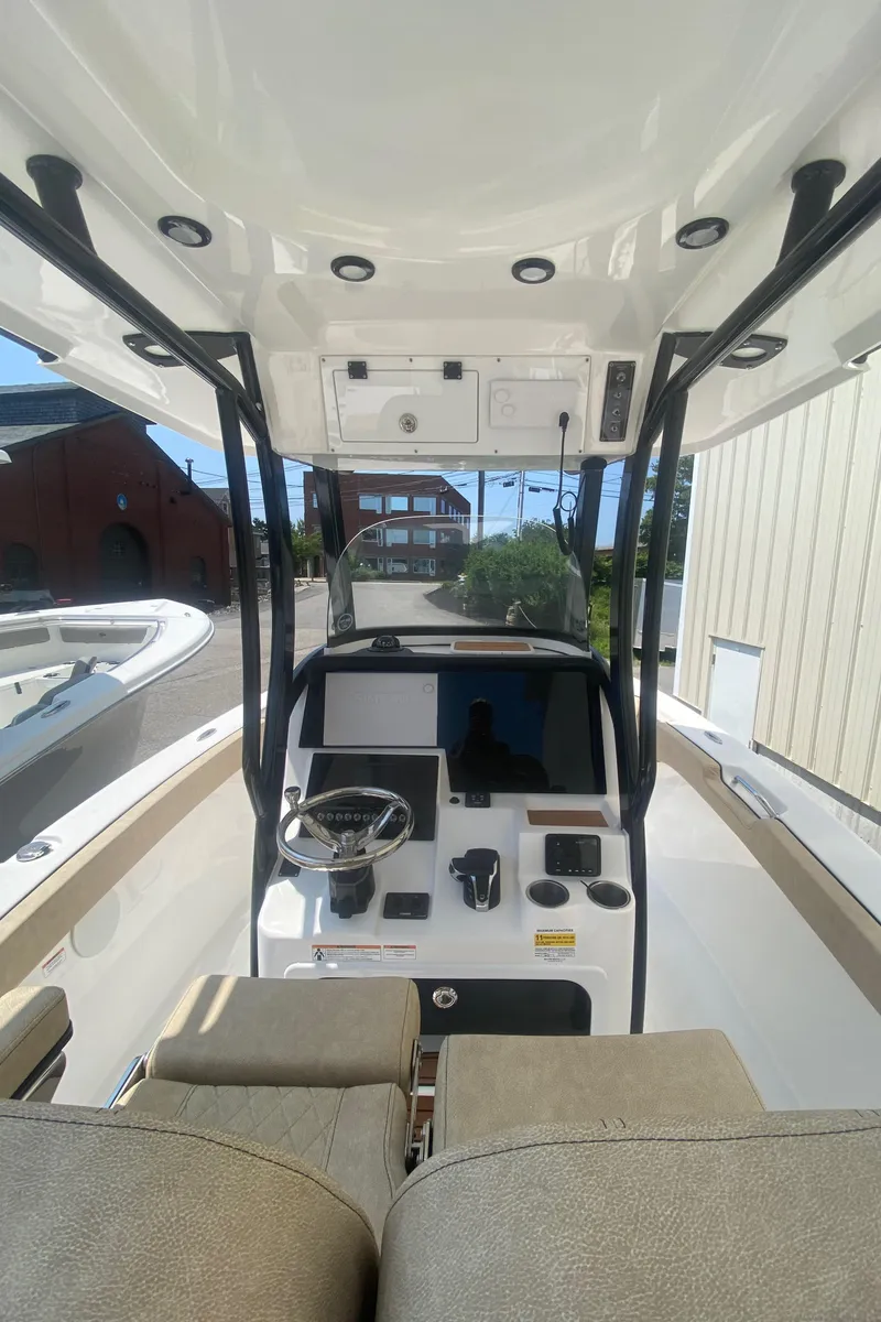 Slide: The Image of 2023 Sea Pro 239 boat interior with modern dashboard and seating. - 13