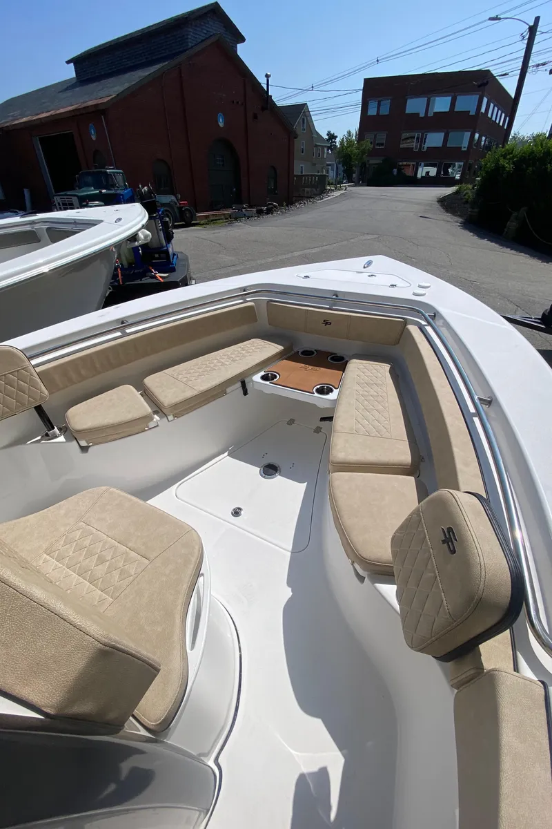 Slide: The Image of 2023 Sea Pro 239 boat with beige seating in a marina. - 6