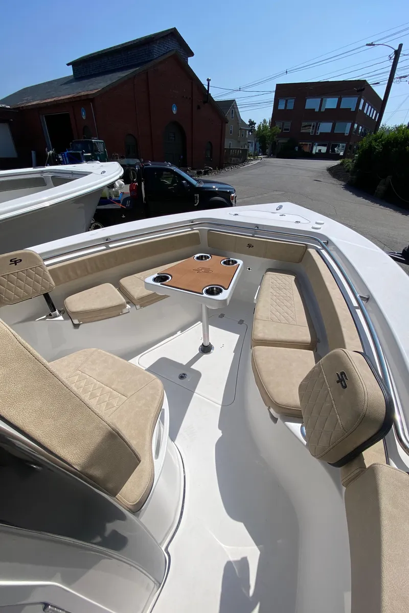 Slide: The Image of 2023 Sea Pro 239 boat with beige seating and a central table. - 7