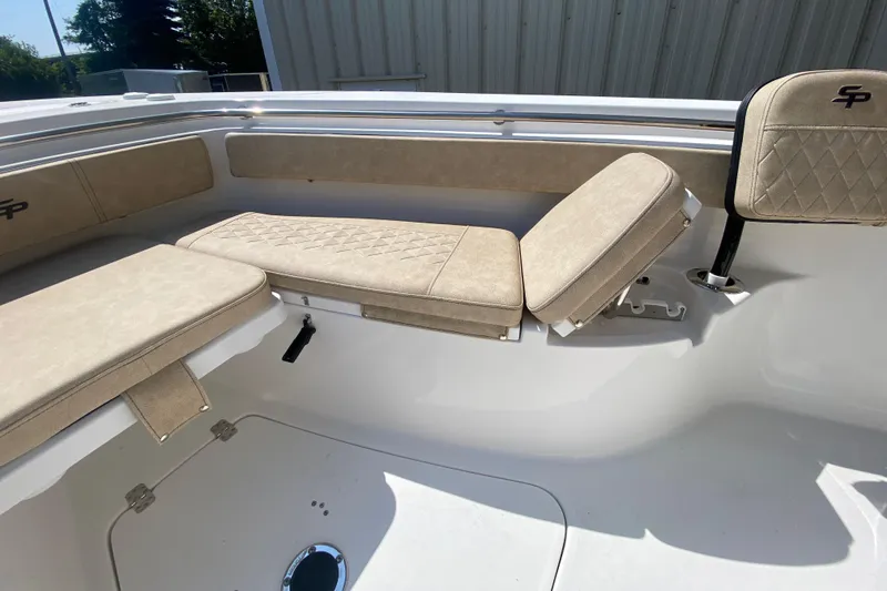 Slide: The Image of 2023 Sea Pro 239 boat with beige cushioned seating. - 9