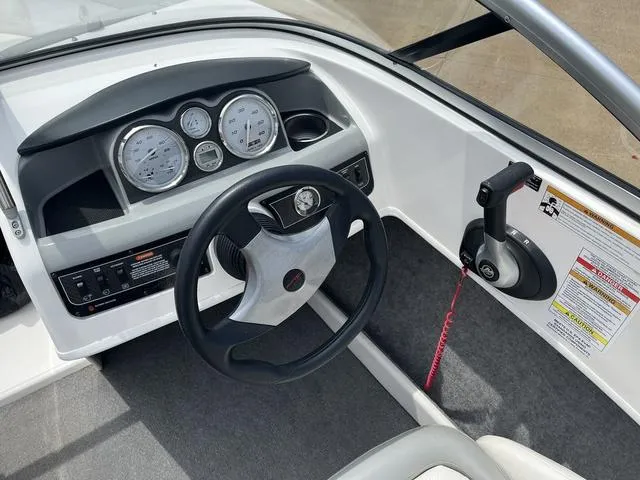 Slide: The Image of 2012 Bayliner 195 Bowrider dashboard and steering wheel. - 8
