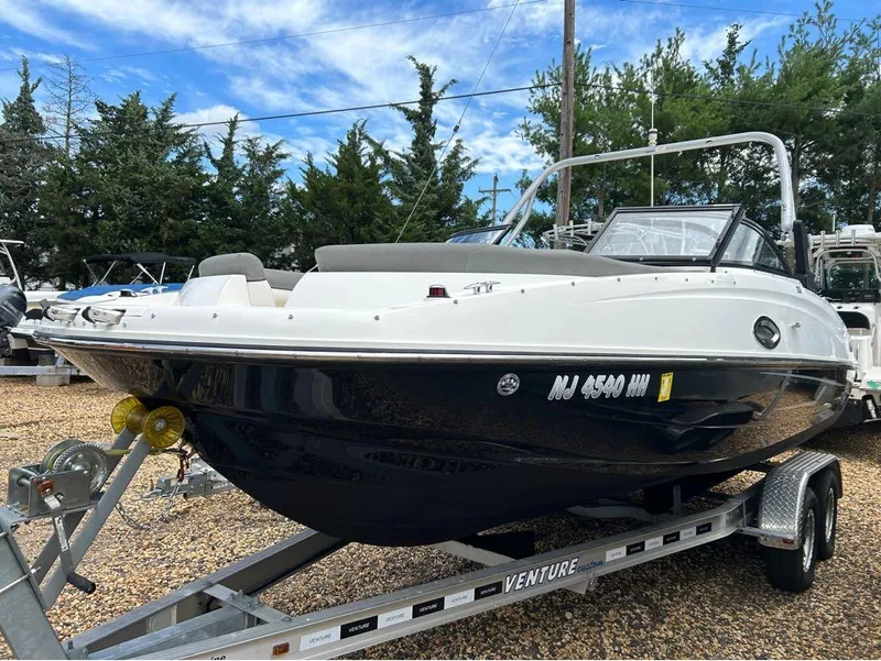 The Image of 2016 Bayliner 215 Deck Boat on a trailer, ready for transport. - 0