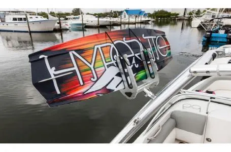 Slide: The Image of 2016 Bayliner 215 Deck Boat with colorful wakeboard at marina. - 12