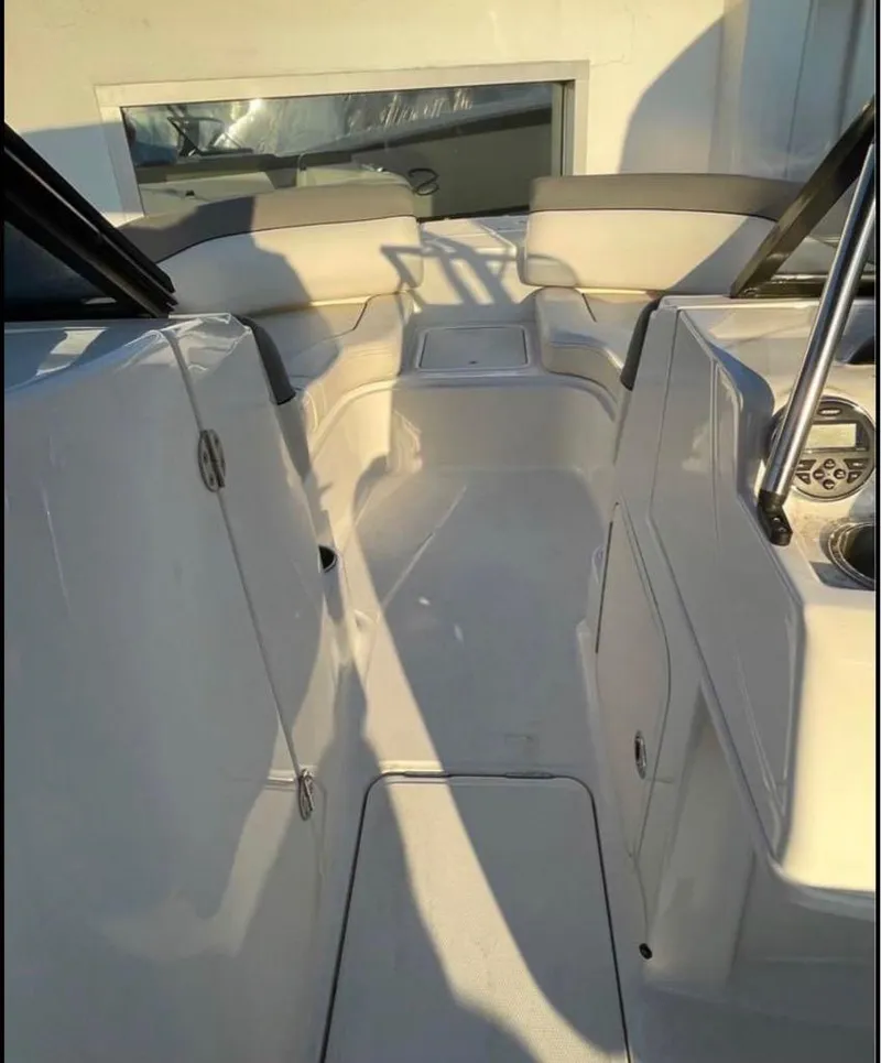 Slide: The Image of 2016 Bayliner 215 Deck Boat interior with seating and control panel. - 17