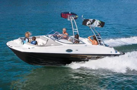 Slide: The Image of 2016 Bayliner 215 Deck Boat cruising on a lake with passengers. - 4