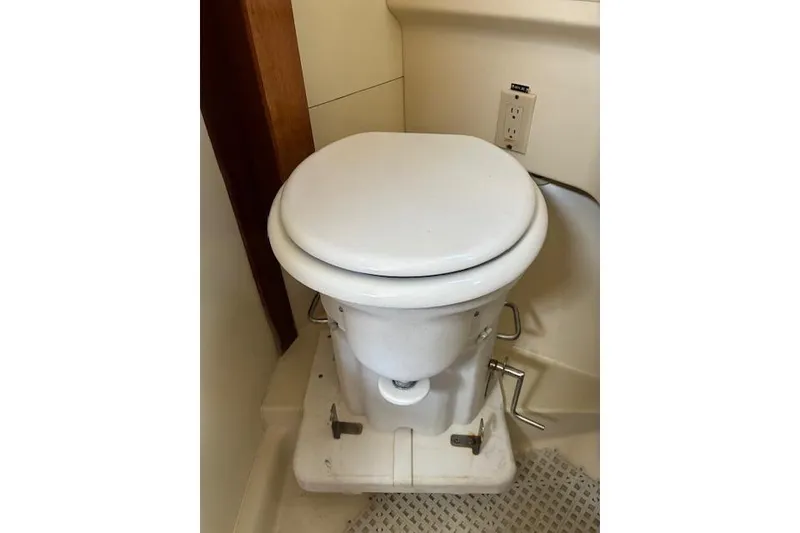 Slide: The Image of White marine toilet in a 1984 Pearson 34 sailboat bathroom. - 11