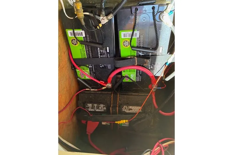 Slide: The Image of Battery compartment of a 1984 Pearson 34 sailboat with connected cables. - 14