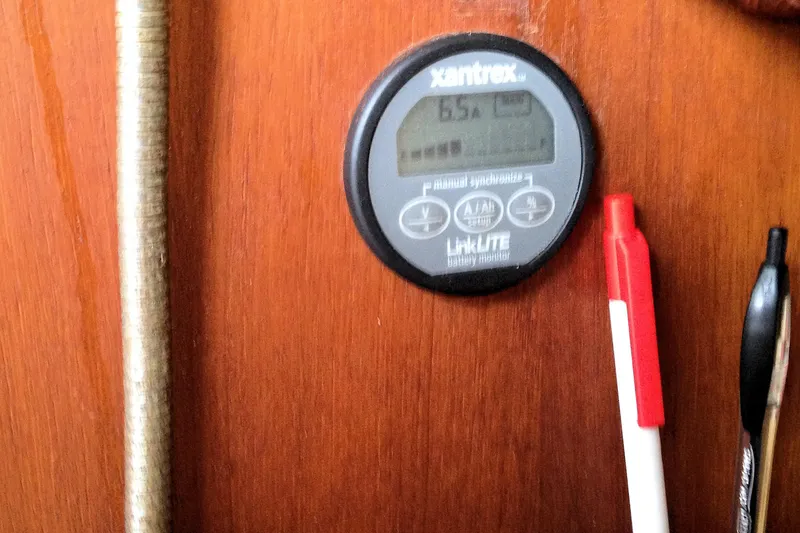 Slide: The Image of Battery monitor on wooden panel of 1984 Pearson 34 sailboat interior. - 17