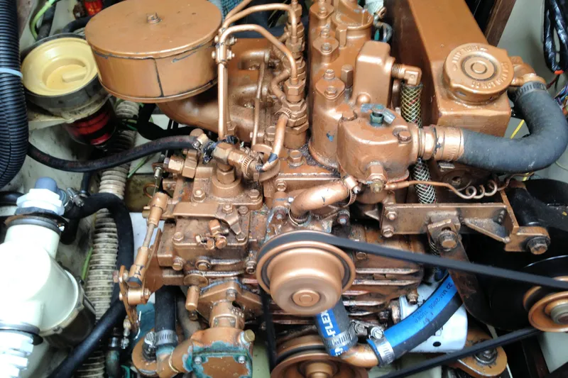 Slide: The Image of Engine of a 1984 Pearson 34 sailboat, showcasing detailed mechanical components. - 19
