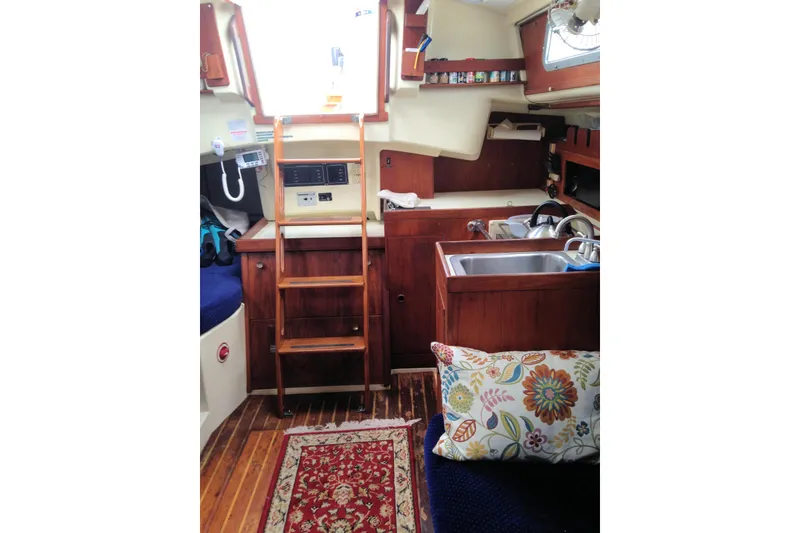 Slide: The Image of Interior of a 1984 Pearson 34 sailboat with wooden cabinetry and nautical decor. - 7