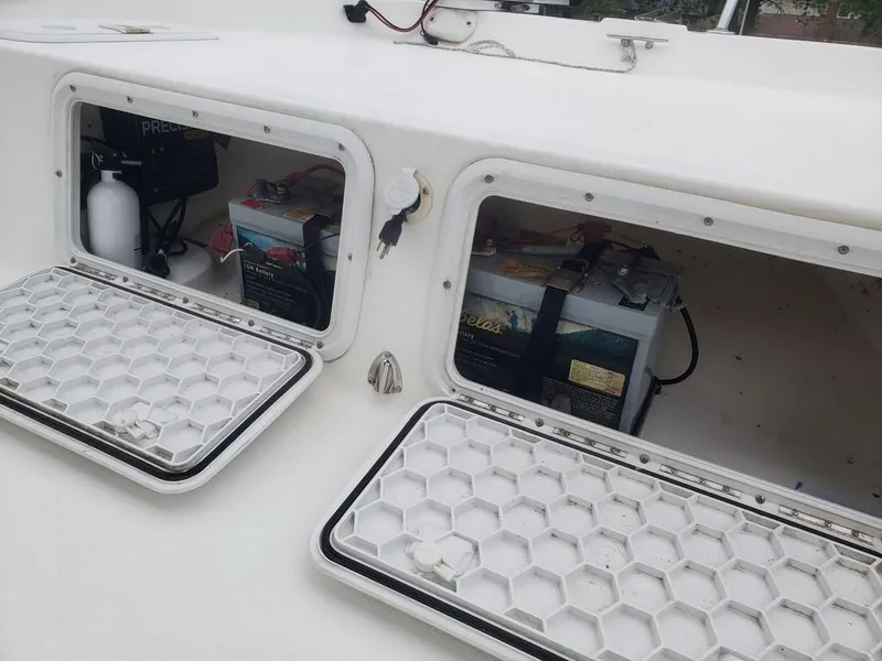 Slide: The Image of Open compartments on a 2008 Caracal 180 boat showing batteries and equipment. - 10