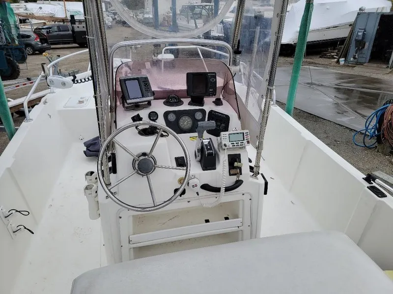Slide: The Image of 2008 Caracal 180 boat cockpit with steering wheel, navigation instruments, and control panel. - 3