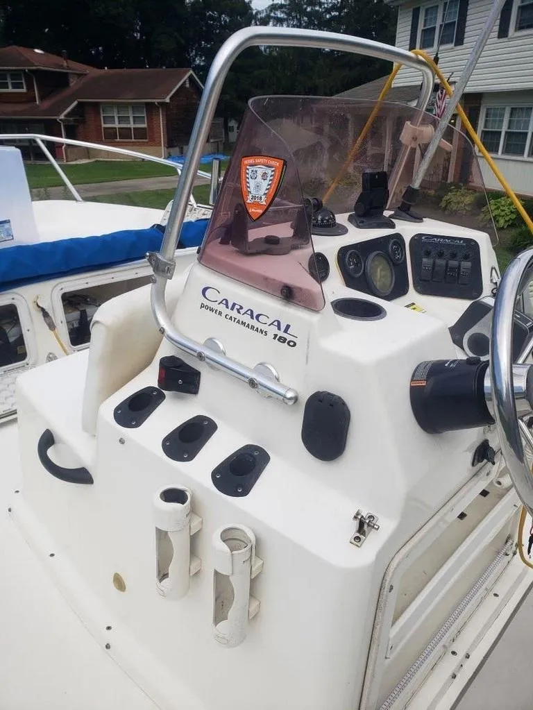 Slide: The Image of Caracal 180 boat console with steering wheel and controls, 2008 model, outdoor setting. - 4