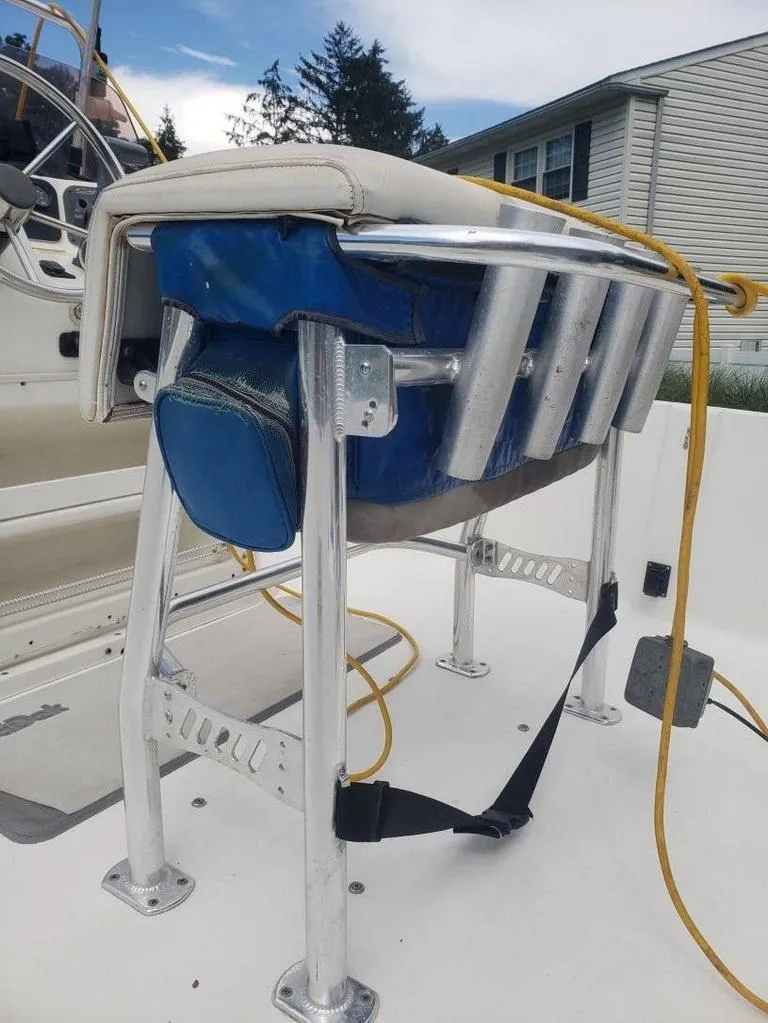 Slide: The Image of Boat seat with blue cushion on Caracal 180, 2008 model, featuring metal frame and rod holders. - 5
