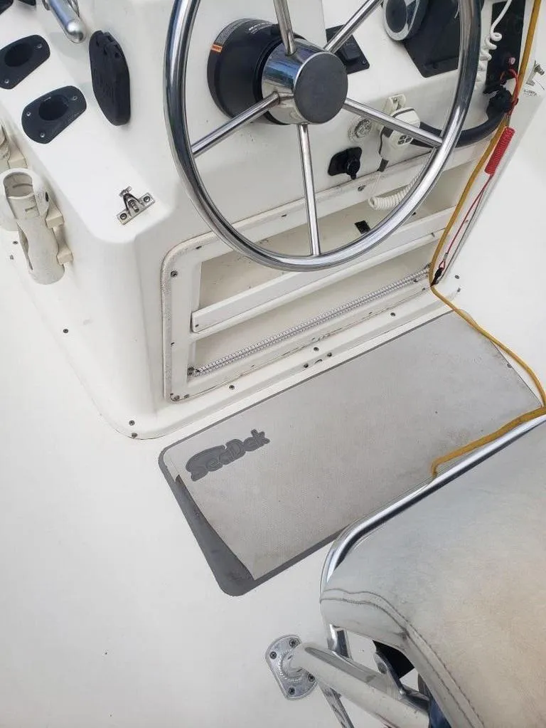 Slide: The Image of Steering wheel and controls of a 2008 Caracal 180 boat, featuring a sleek design. - 8