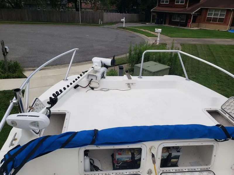 Slide: The Image of Caracal 180 boat, 2008 model, parked in a residential area with visible equipment. - 9