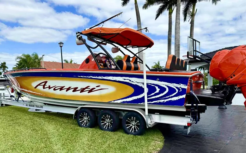 Slide: The Image of 2008 Avanti 36 boat on a trailer with vibrant graphics and orange canopy. - 4