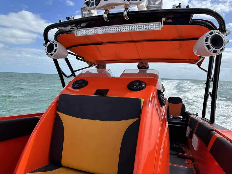 Slide: The Image of 2008 Avanti 36 boat with orange and black interior on the ocean. - 5