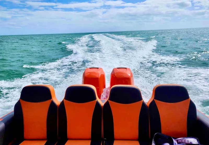 Slide: The Image of Rear view of 2008 Avanti 36 boat with orange seats on open water. - 8