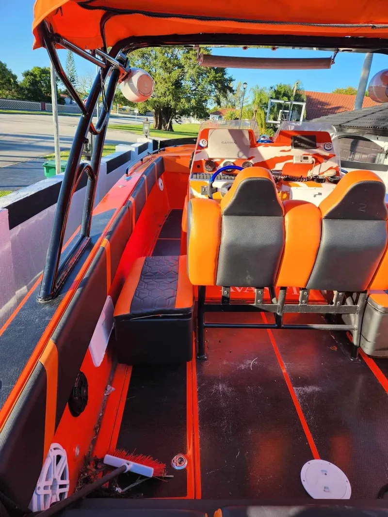 Slide: The Image of 2008 Avanti 36 boat interior with orange and black seating and dashboard. - 9