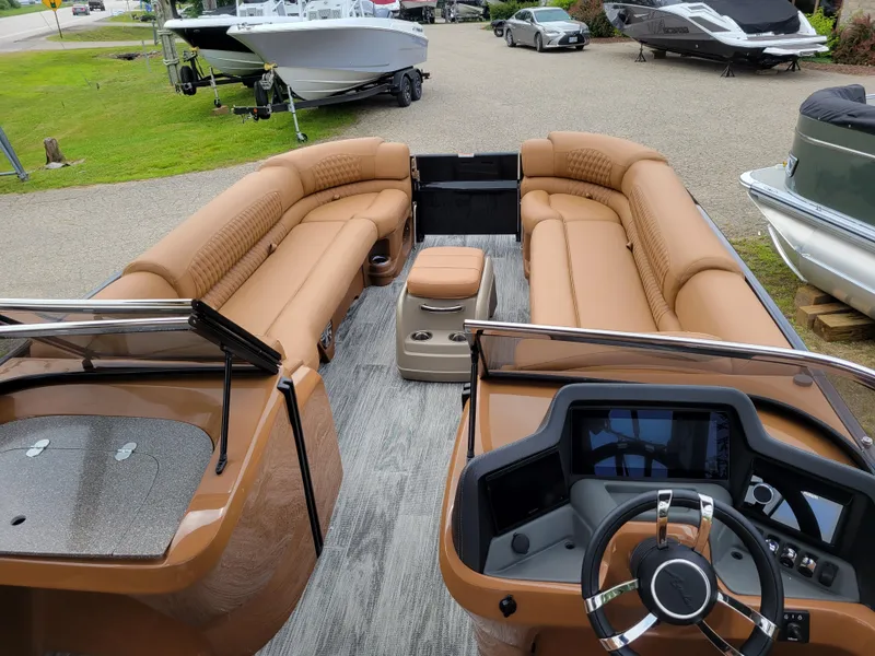 Slide: The Image of 2024 Avalon Excalibur WQL 27 Tri-Toon boat interior with tan leather seating. - 10
