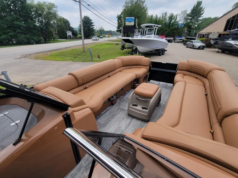 Slide: The Image of 2024 Avalon Excalibur WQL 27 Tri-Toon boat with luxurious tan seating. - 12