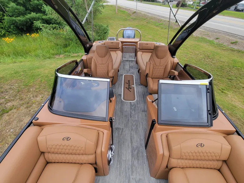 Slide: The Image of 2024 Avalon Excalibur WQL 27 Tri-Toon boat interior with luxurious tan seating. - 14