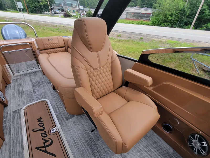Slide: The Image of Luxurious interior of 2024 Avalon Excalibur WQL 27 Tri-Toon boat with tan leather seats. - 16