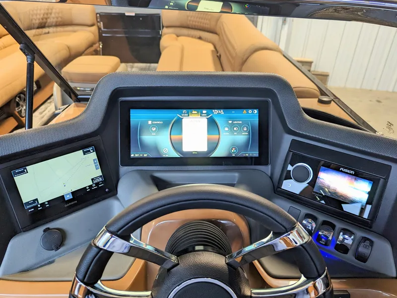 Slide: The Image of 2024 Avalon Excalibur WQL 27 Tri-Toon dashboard with advanced navigation and control screens. - 18