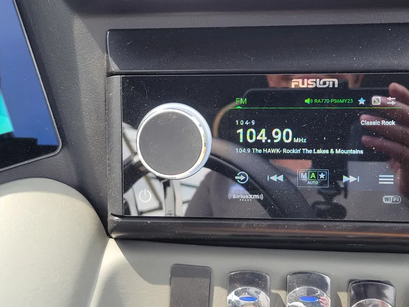 Slide: The Image of Fusion radio display in 2024 Avalon Excalibur WQL 27 Tri-Toon showing 104.9 FM. - 21