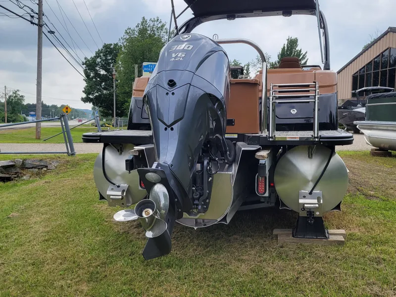 Slide: The Image of 2024 Avalon Excalibur WQL 27 Tri-Toon boat with powerful outboard motor. - 25