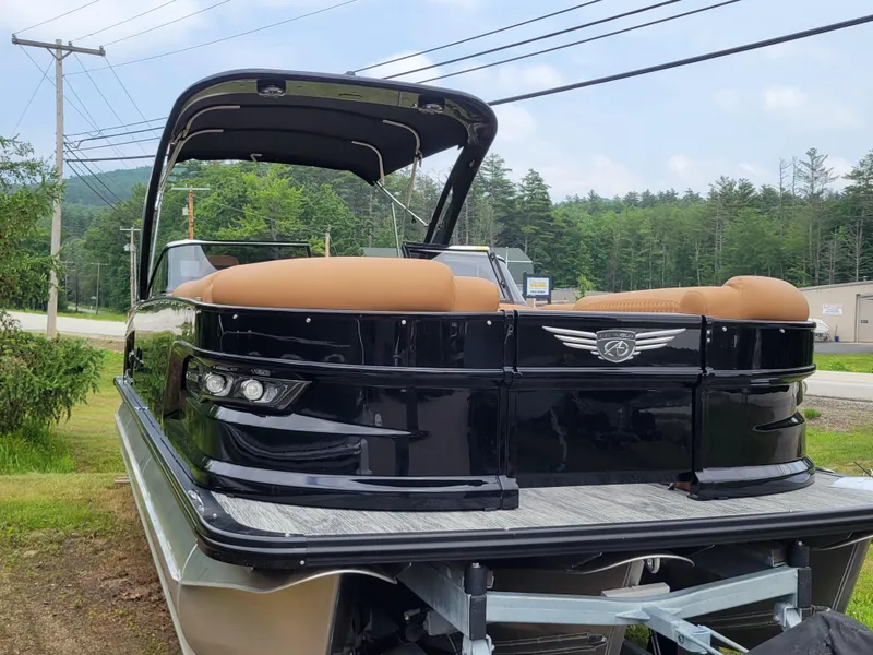 Slide: The Image of 2024 Avalon Excalibur WQL 27 Tri-Toon boat with black exterior and tan seats. - 8