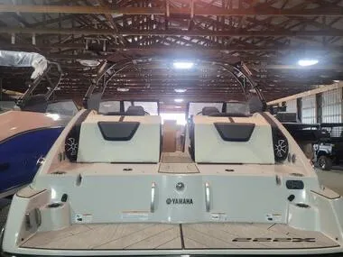 Slide: The Image of 2023 Yamaha Boats 222XD in a warehouse, showcasing rear seating and sleek design. - 3