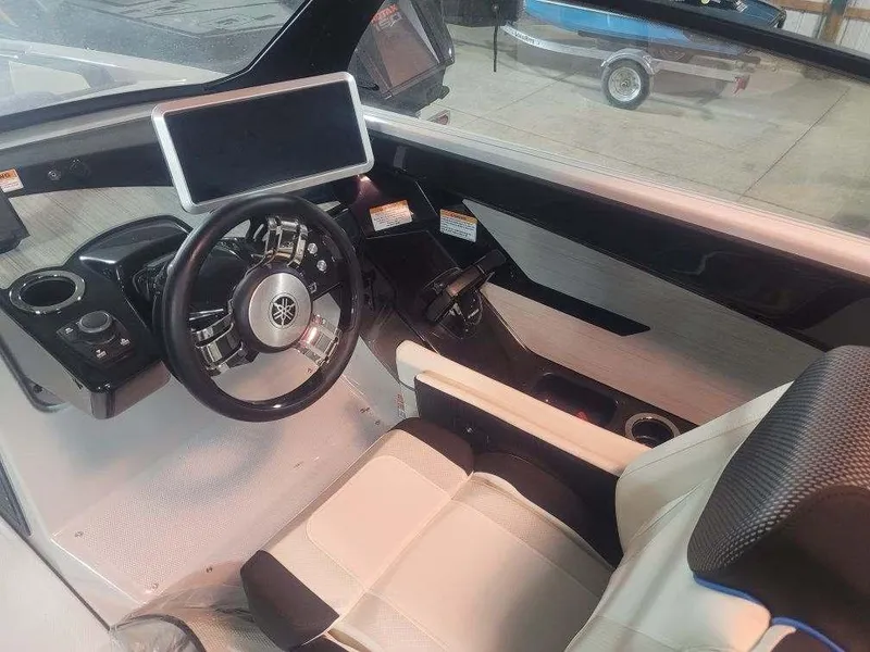 Slide: The Image of 2023 Yamaha Boats 222XD cockpit with modern steering and touchscreen display. - 6