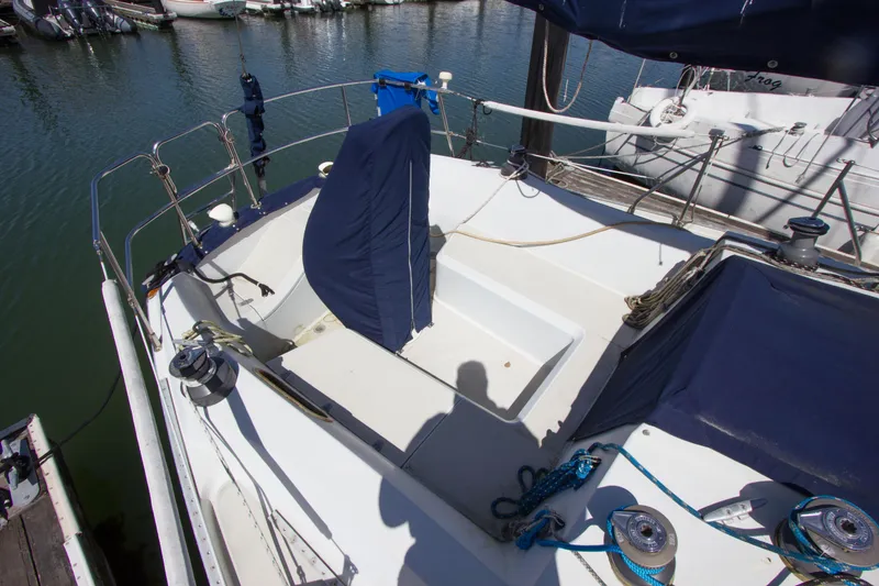 Slide: The Image of 1987 Ericson Mk III sloop cockpit with covered seating, docked at marina. - 10