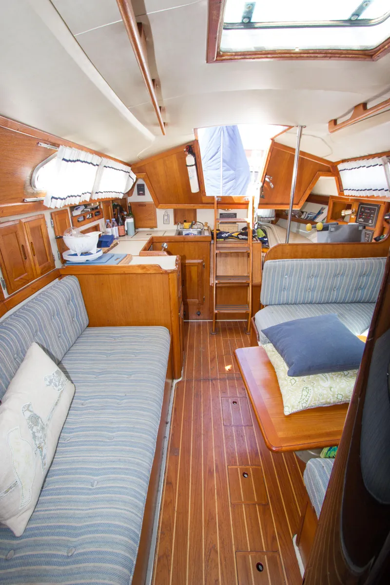 Slide: The Image of Interior of 1987 Ericson Mk III sloop with wood finish and striped upholstery. - 2