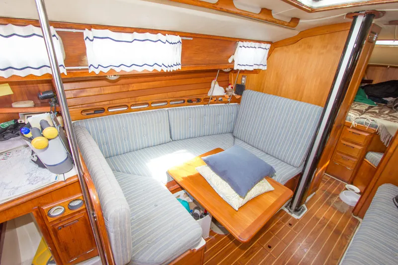 Slide: The Image of 1987 Ericson Mk III sloop interior with cozy seating and wooden accents. - 3