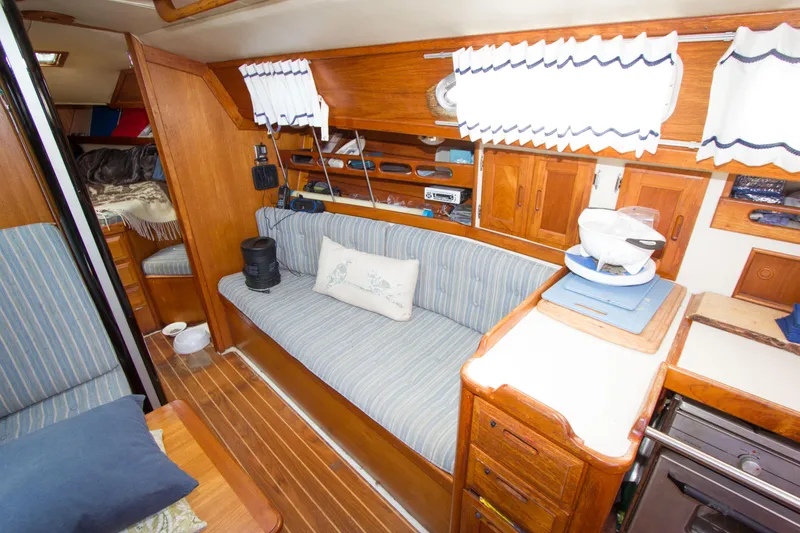 Slide: The Image of Interior of 1987 Ericson Mk III sloop with wooden cabinetry and striped seating. - 4