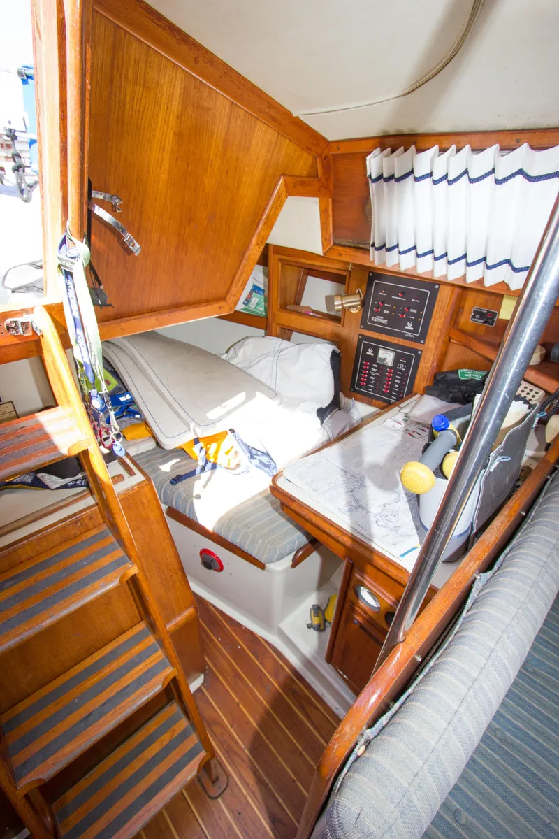 Slide: The Image of Interior of 1987 Ericson Mk III sloop with wooden cabinetry and nautical decor. - 7