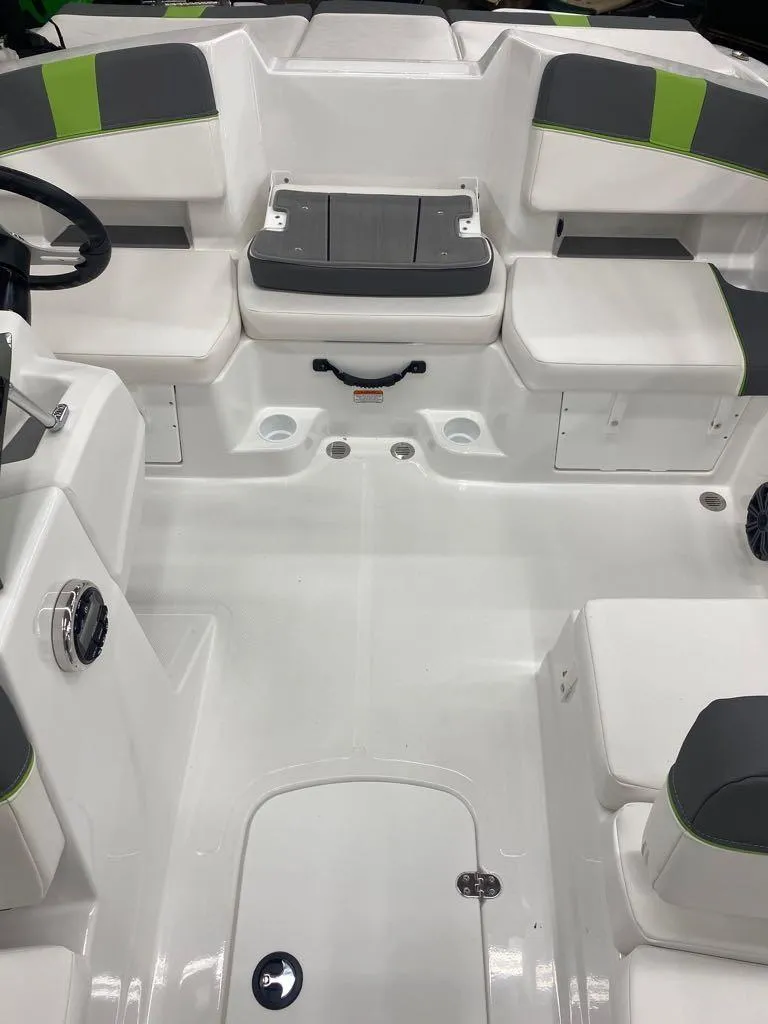 Slide: The Image of 2024 Tahoe T18 boat interior with white and gray seating, green accents, and storage compartments. - 3