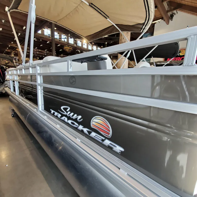 Slide: The Image of 2024 Sun Tracker SportFish 22 DLX pontoon boat on trailer. - 1