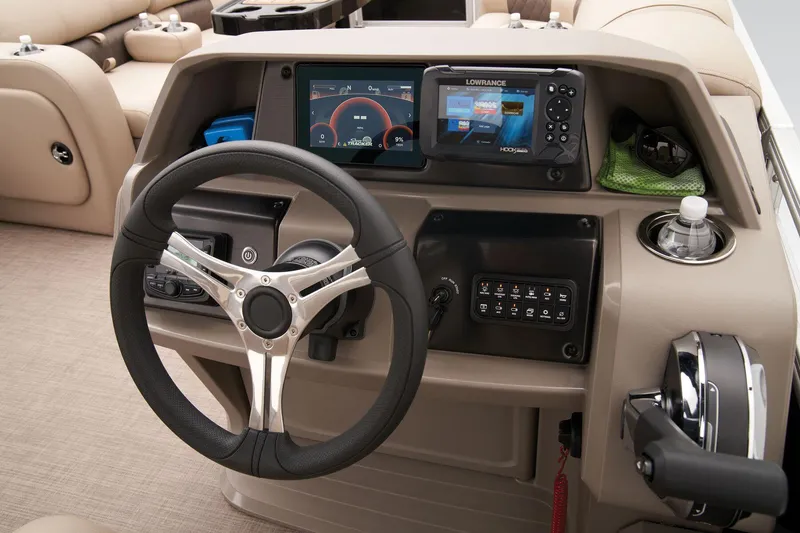 Slide: The Image of 2024 Sun Tracker SportFish 22 DLX boat dashboard with steering wheel and navigation controls. - 38
