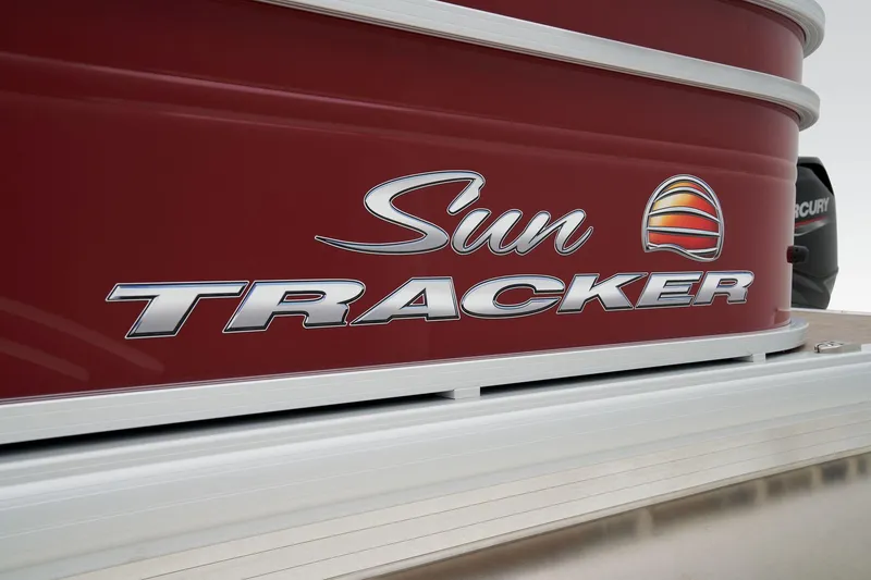 Slide: The Image of 2024 Sun Tracker Party Barge 20 DLX logo on red boat exterior. - 22