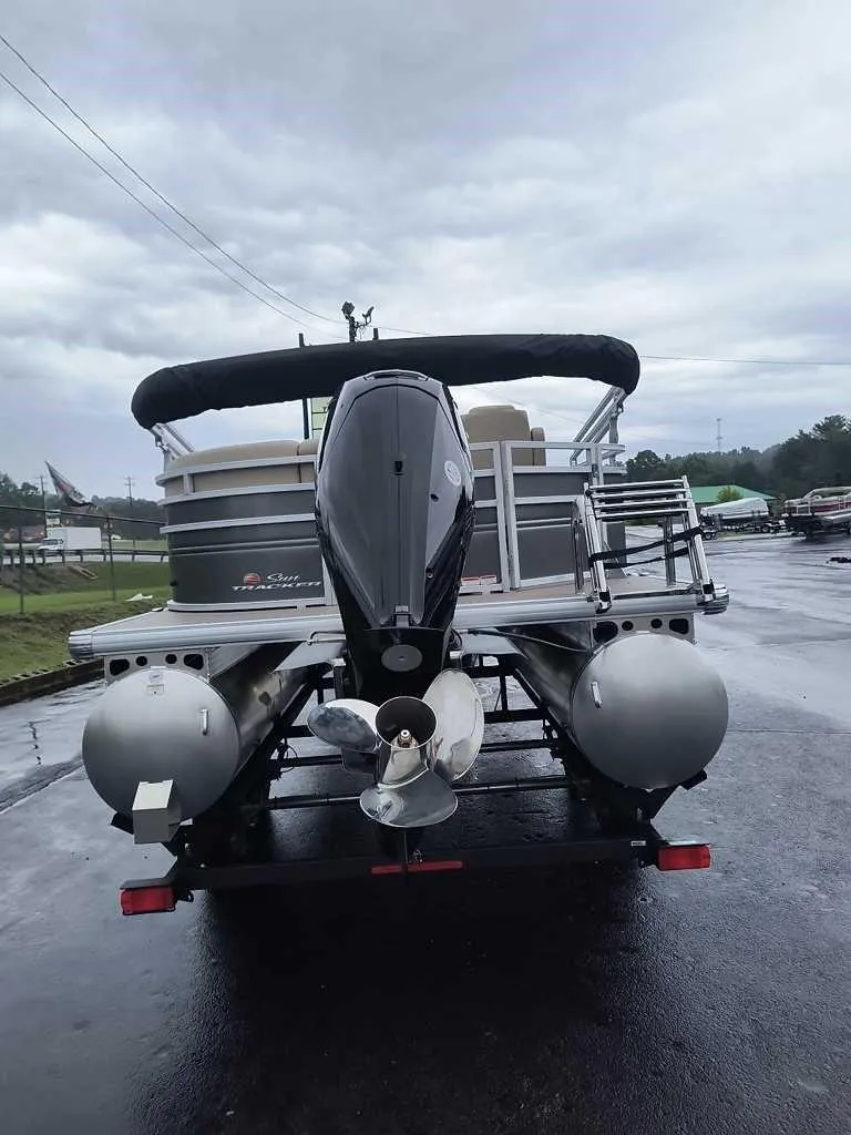 Slide: The Image of 2024 Sun Tracker Party Barge 20 DLX pontoon boat, rear view on a trailer. - 3