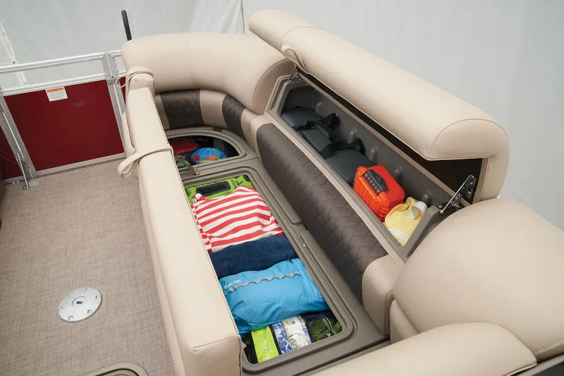 Slide: The Image of Sun Tracker Party Barge 22 XP3 2024 interior storage compartments with seating and gear. - 21